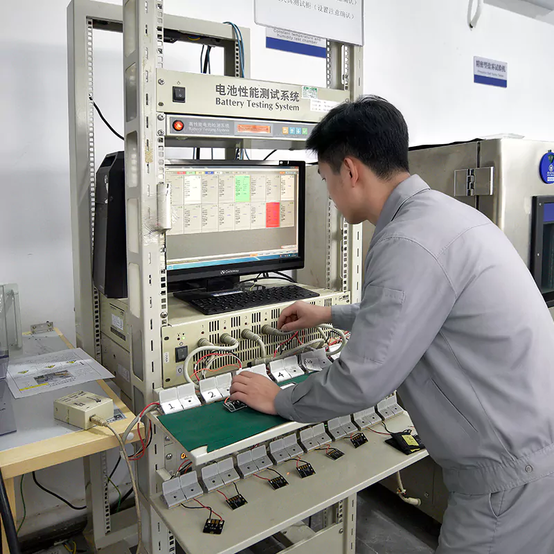 Technician reviewing battery performance testing equipment for UAV battery quality control